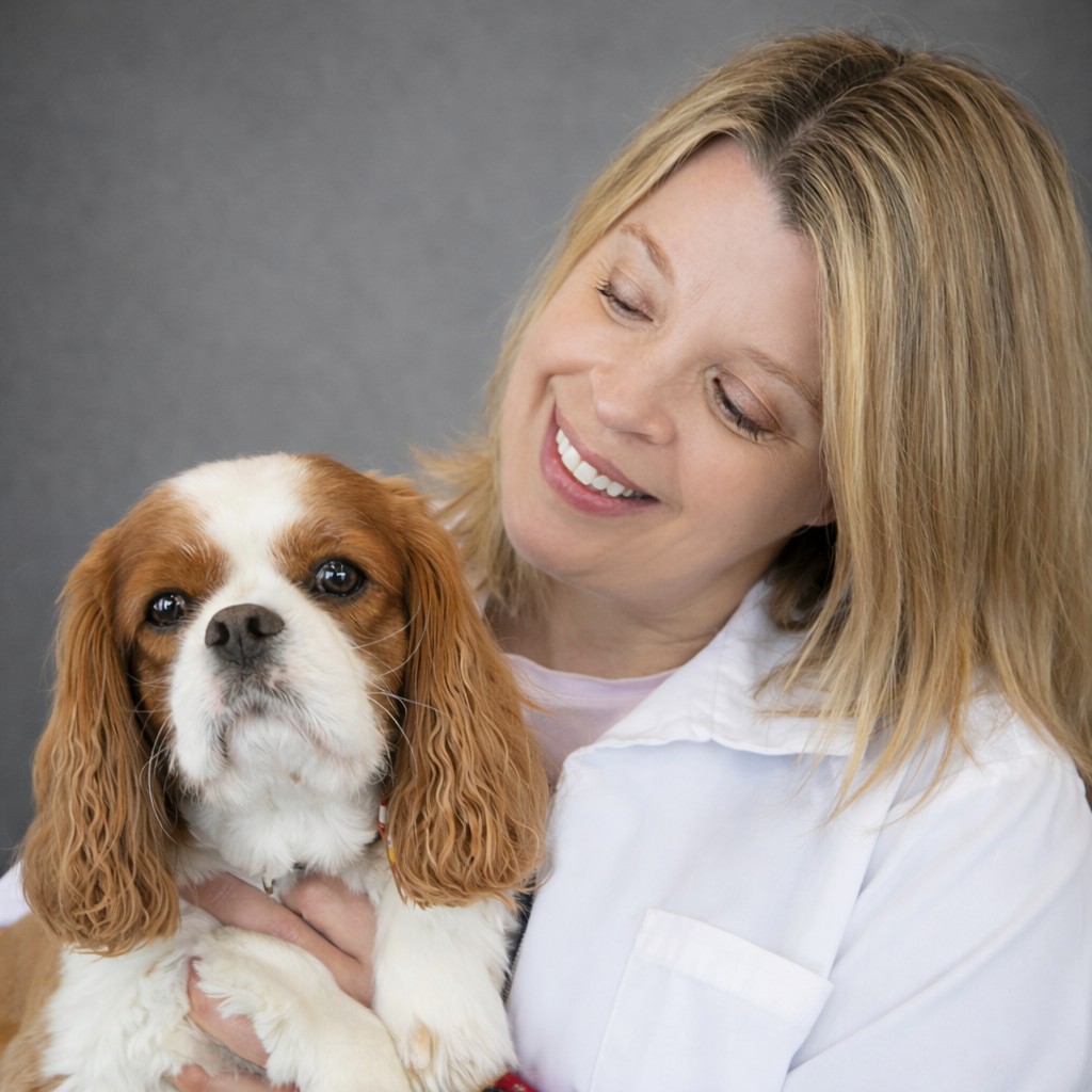 Prairie Lakes Pet Hospital staff member with a happy dog
